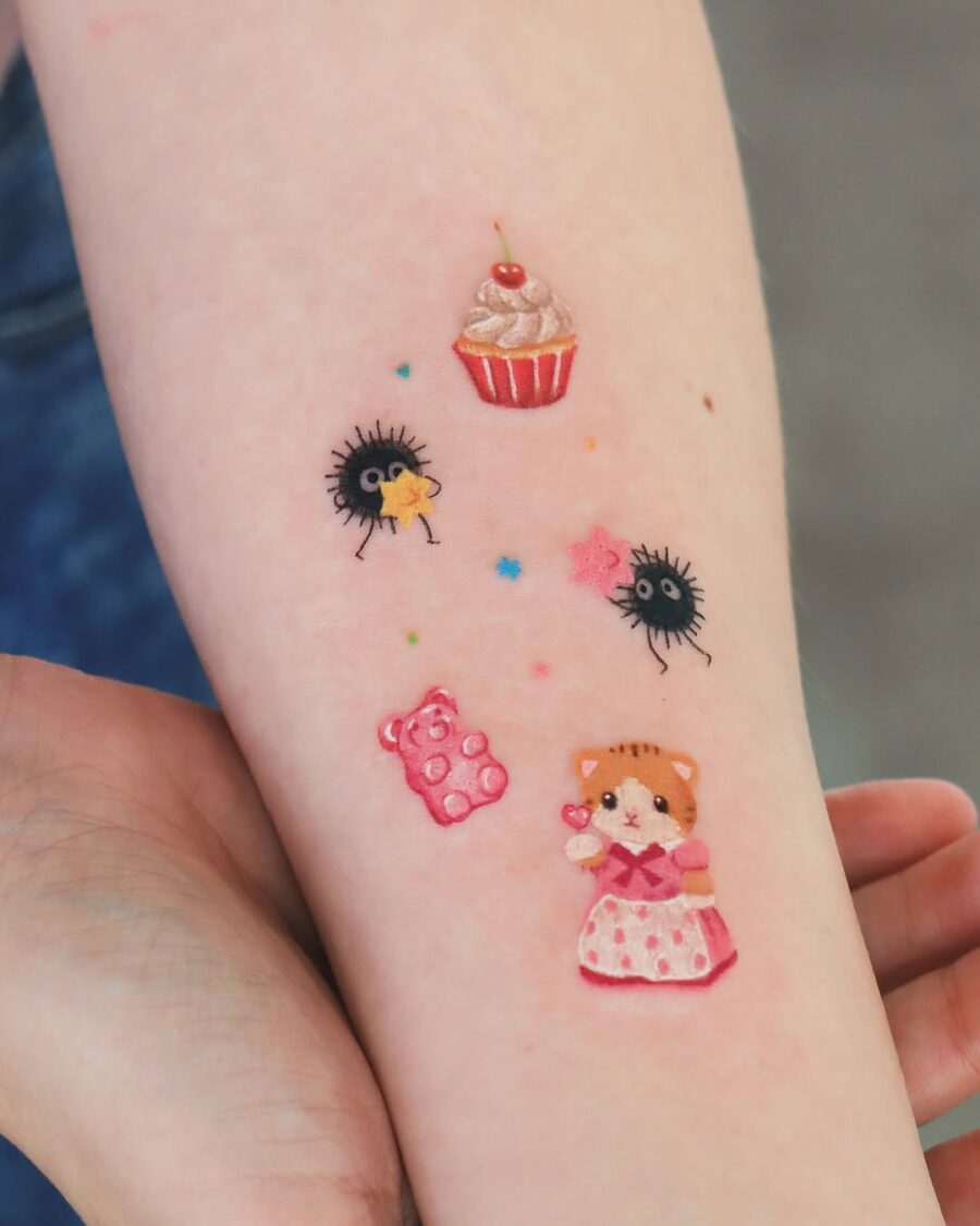 Adorable cupcake tattoo with whimsical characters