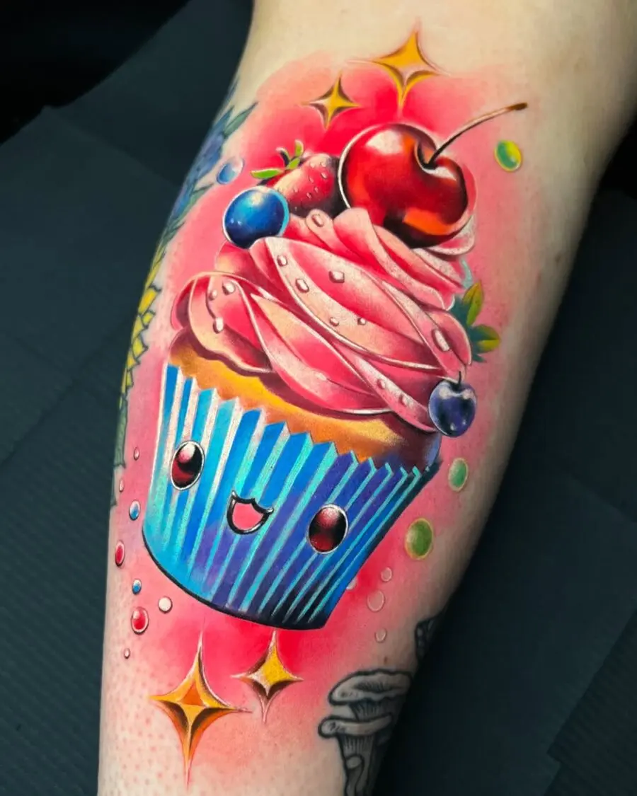 Whimsical cupcake tattoo bursting with color