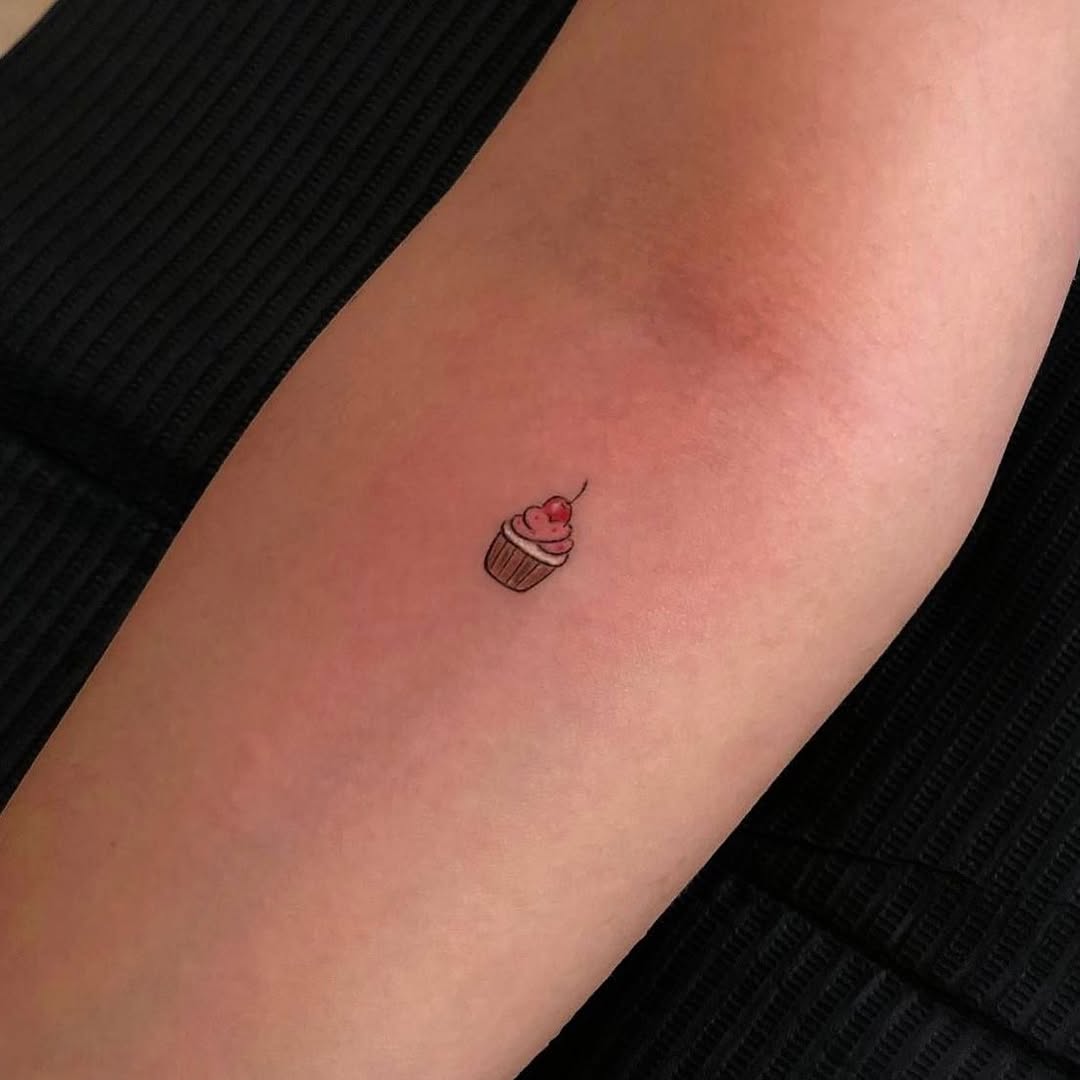 Adorable small cupcake tattoo on the arm