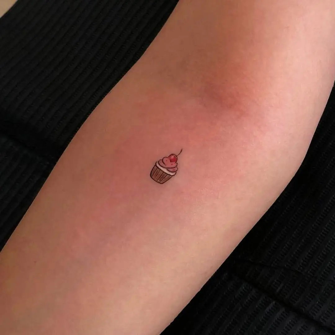 Adorable small cupcake tattoo on the arm