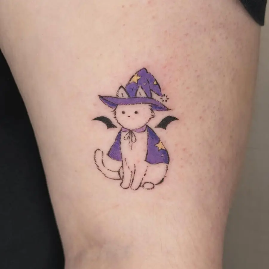 Adorable cat with a whimsical witch hat tattoo