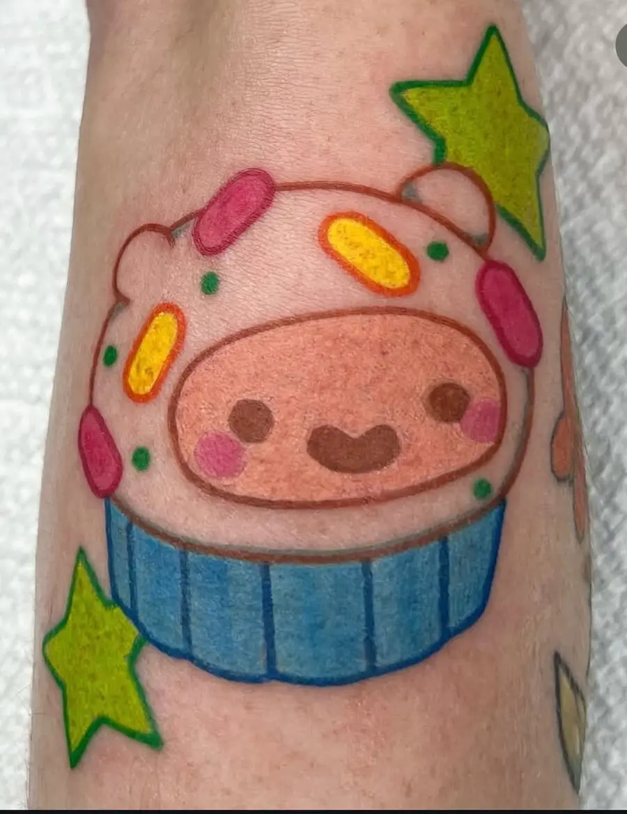 Adorable cupcake tattoo with vibrant stars