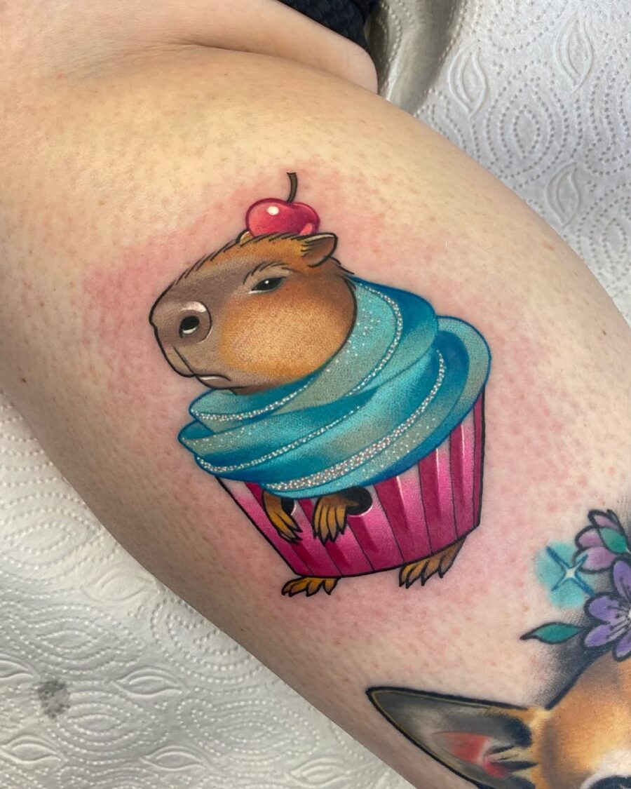 Adorable cupcake tattoo featuring a capybara