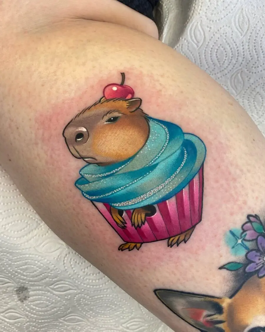Adorable cupcake tattoo featuring a capybara