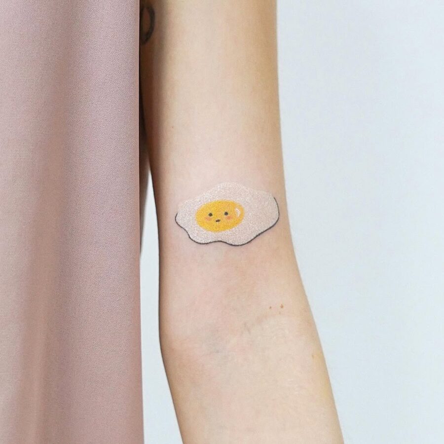 Charming minimalist egg tattoo for playful vibes
