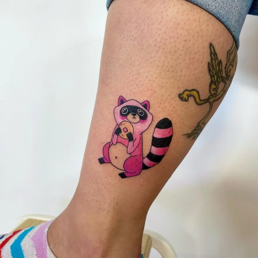 Adorable raccoon holding a bagel tattoo