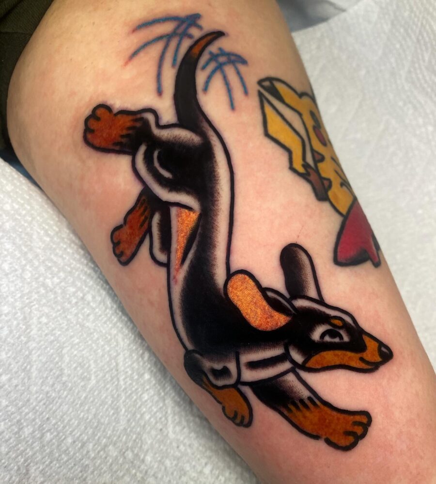 Playful dachshund tattoo in vibrant hues