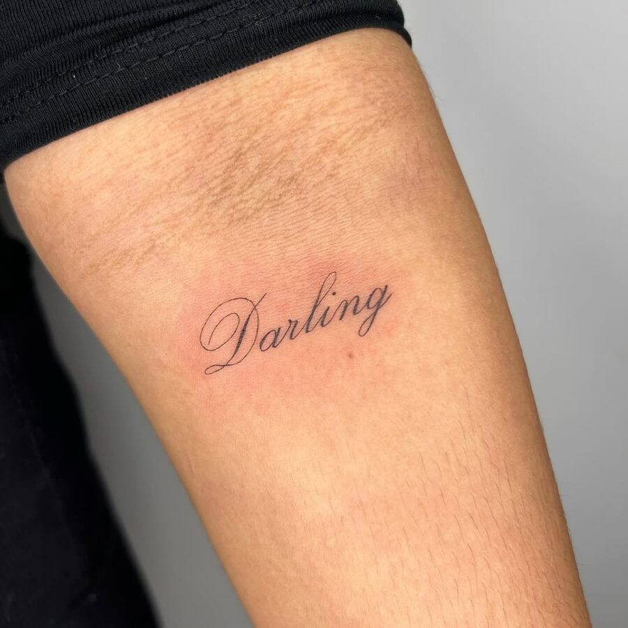 Minimalistic handwriting tattoo of the word 'Darling'