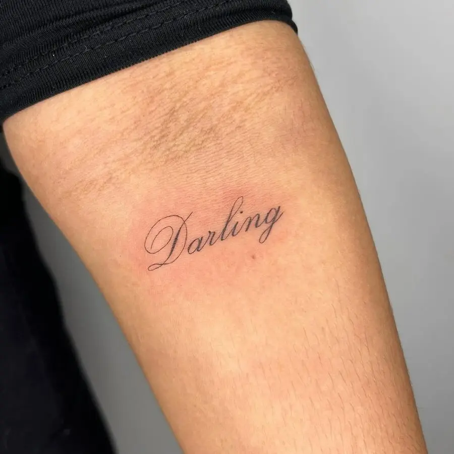 Minimalistic handwriting tattoo of the word 'Darling'