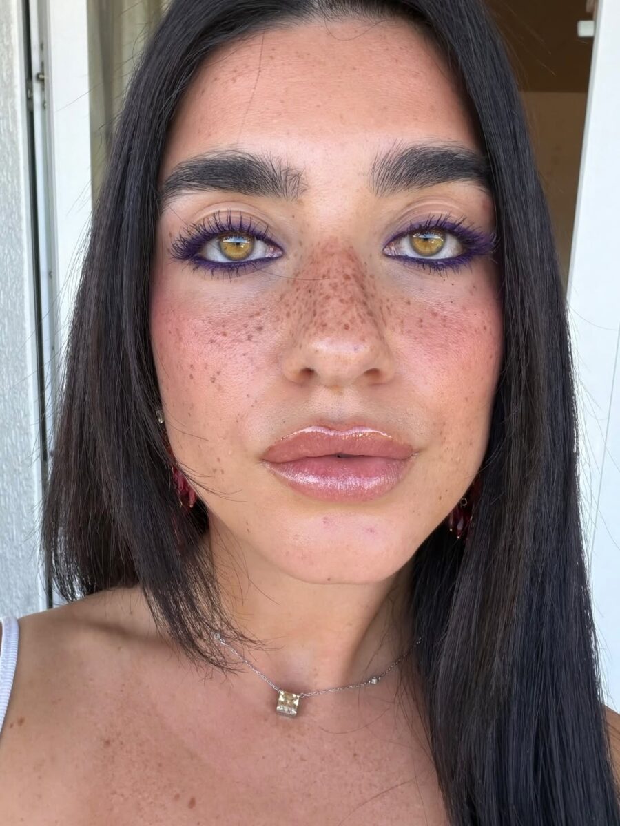 Vibrant purple eye makeup with glossy lips