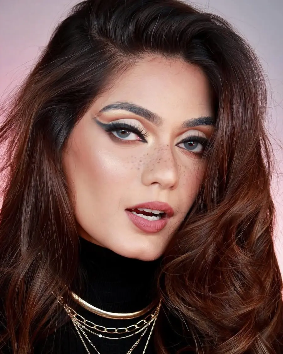 Bold eyeliner paired with natural freckles