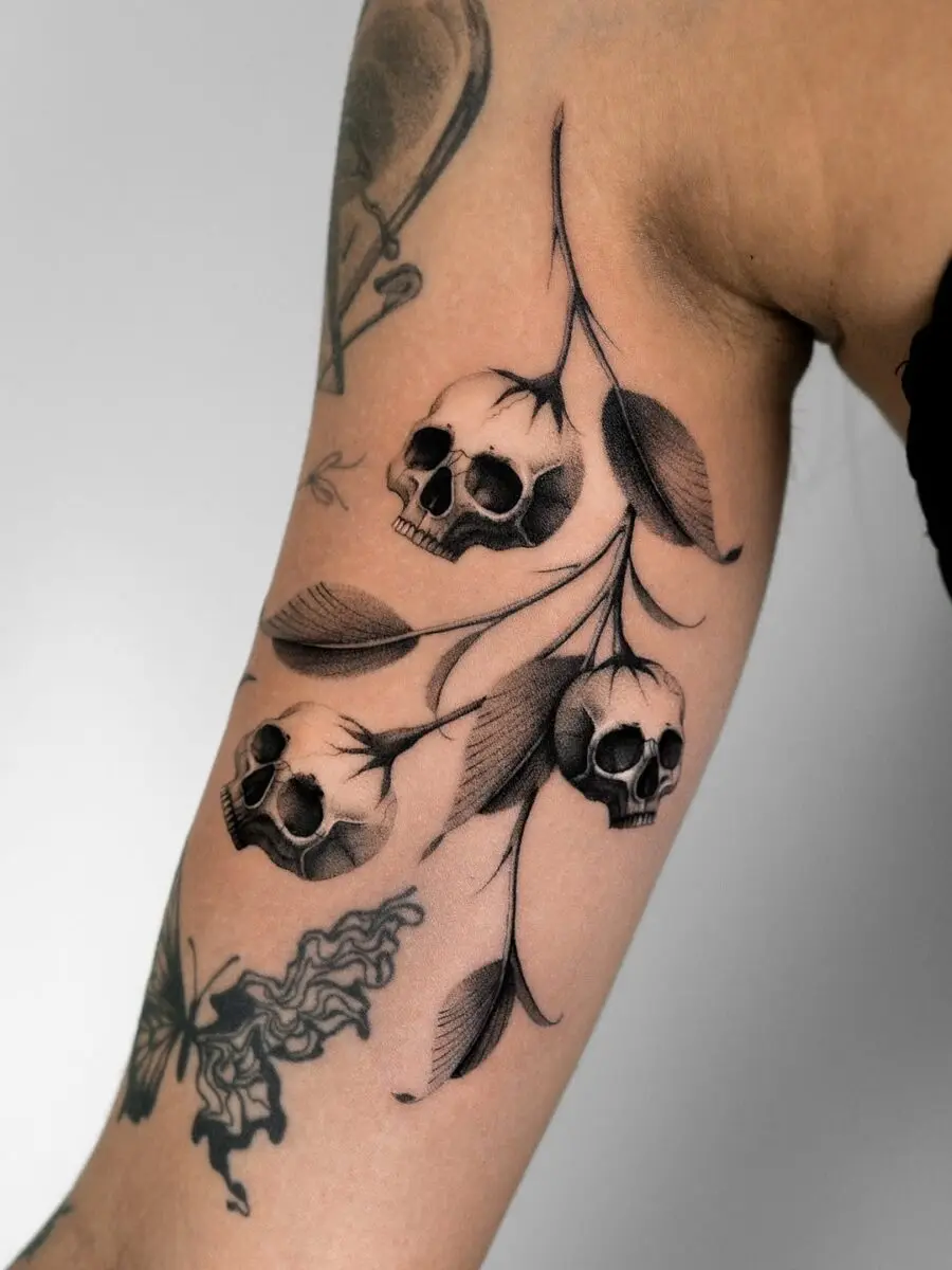 Intricate skulls interwoven with delicate foliage.