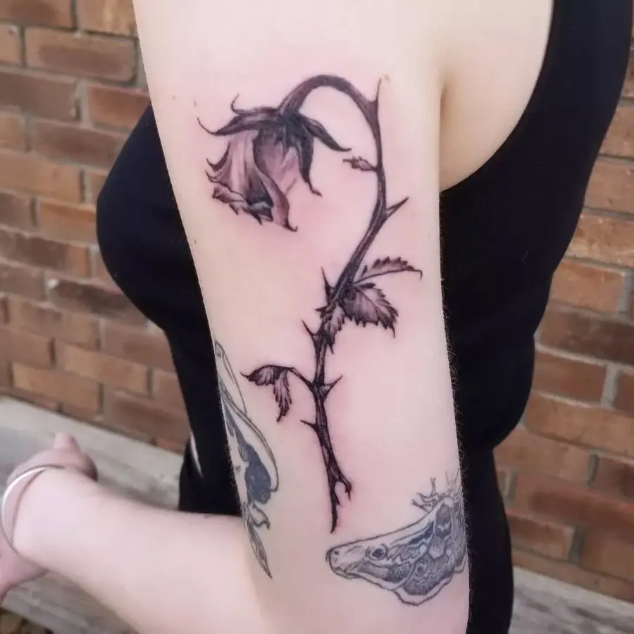 Elegant black and white dead flower tattoo