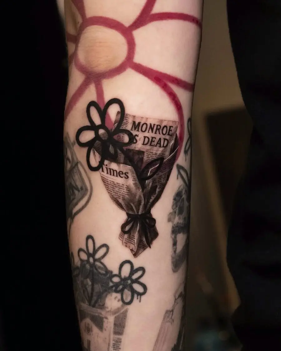 Unique dead flower tattoo with newspaper design