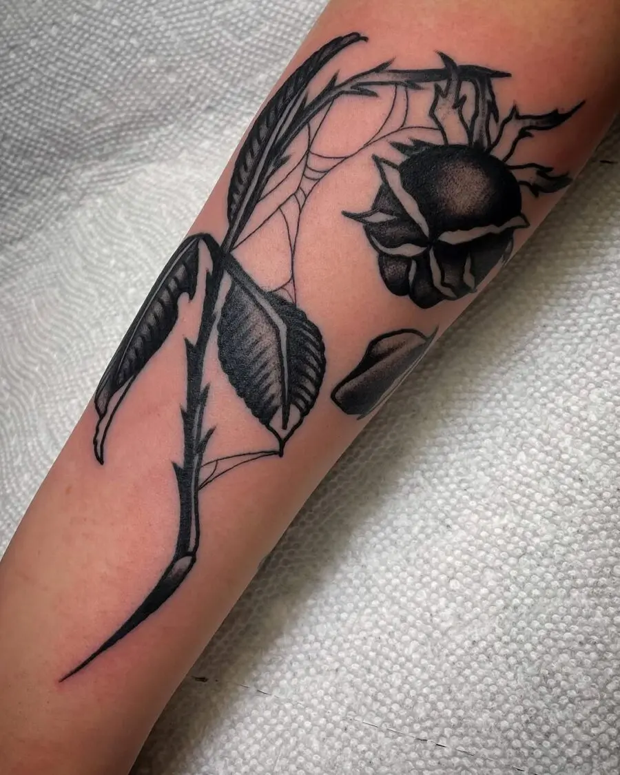Elegant black ink dead flower tattoo design