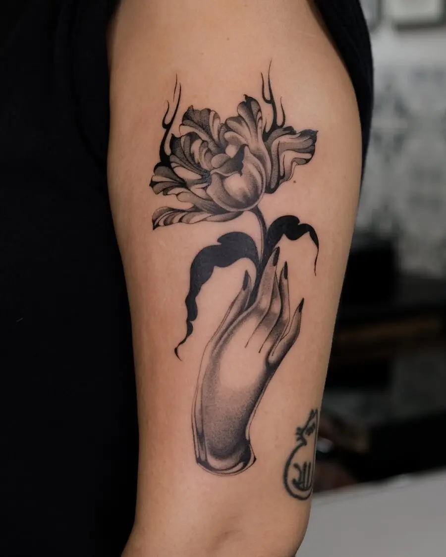 Elegant dead flower tattoo with a hand gesture