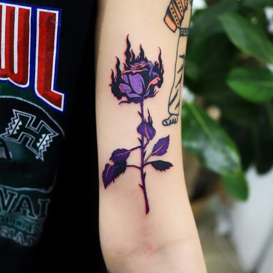 A striking rose tattoo adorned with flames