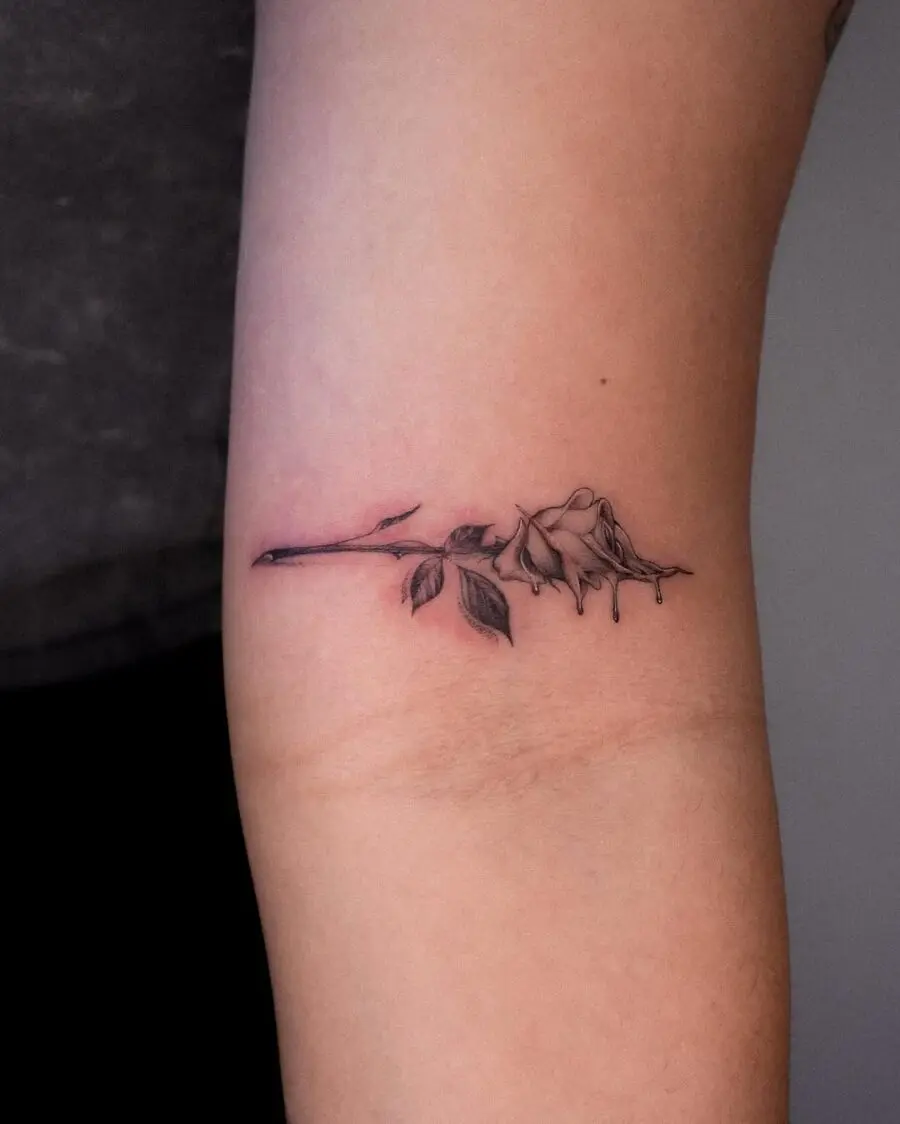 Elegant dead rose tattoo with subtle details