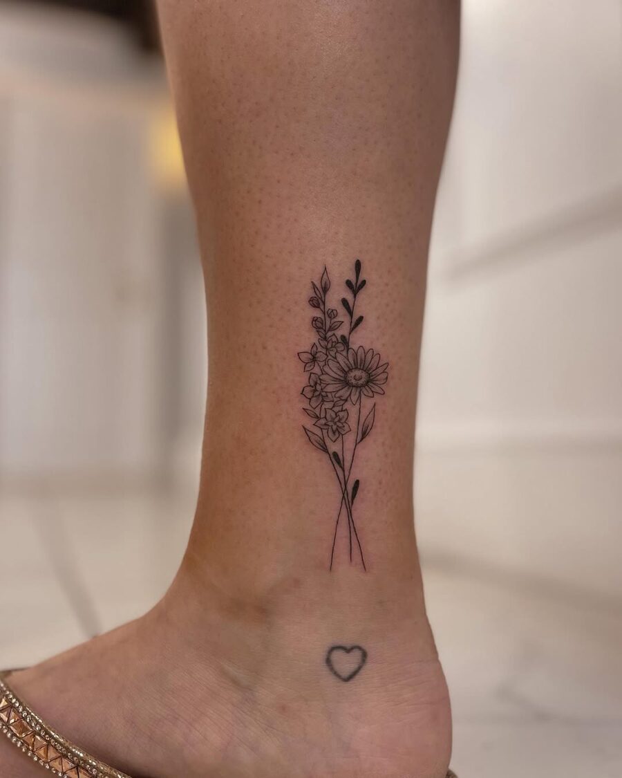 Elegant floral ankle tattoo with delicate details