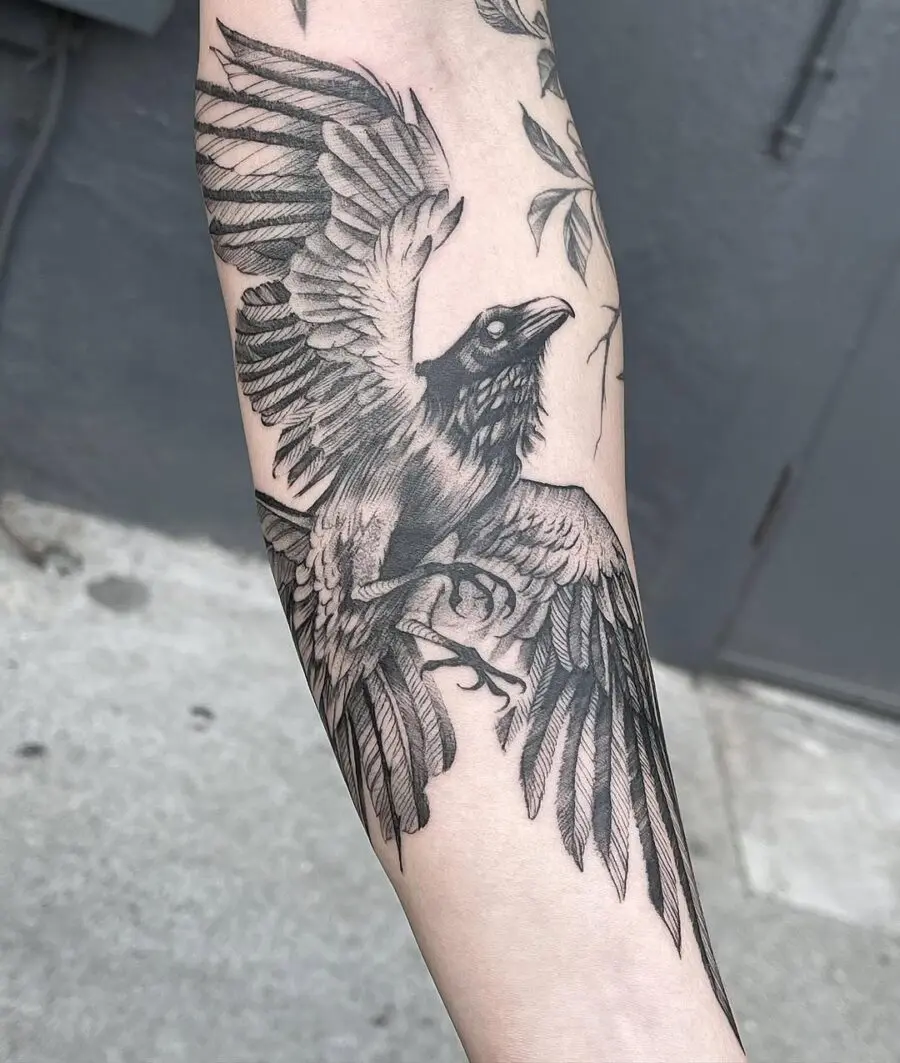 Stunning black and gray raven in flight tattoo