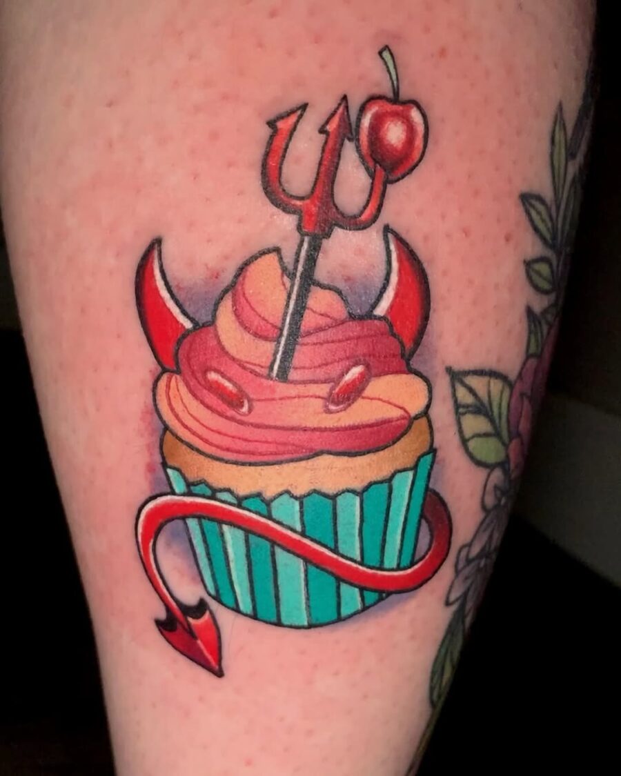 Whimsical devil-themed cupcake tattoo design