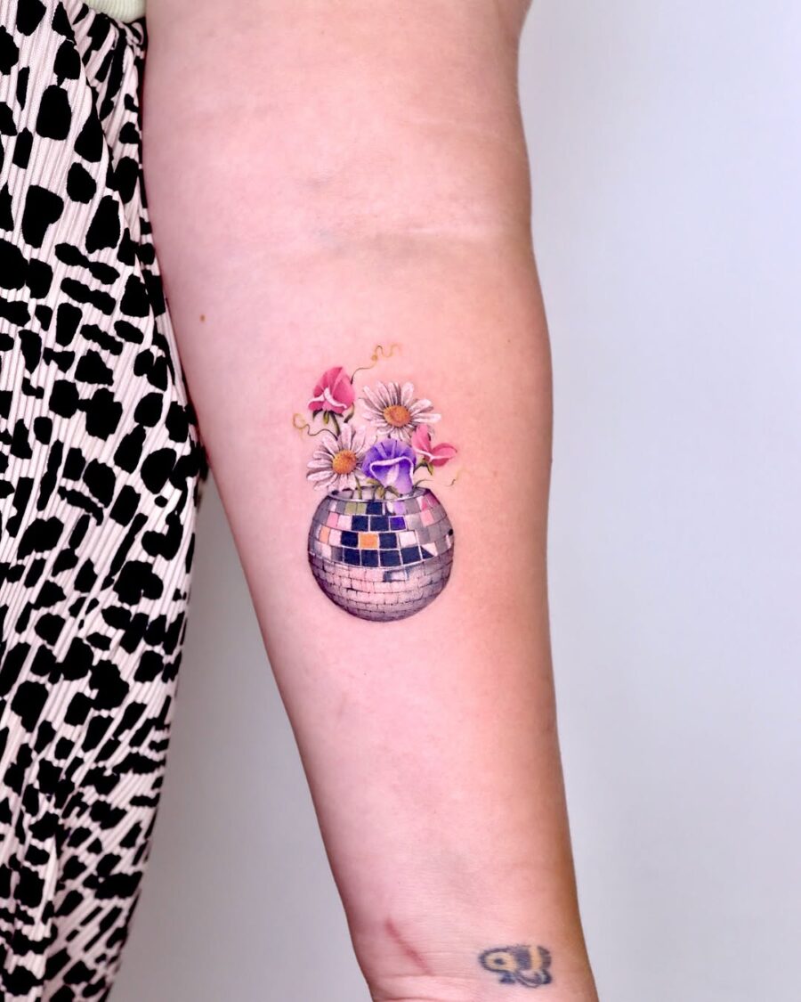 Colorful flowers in disco ball tattoo
