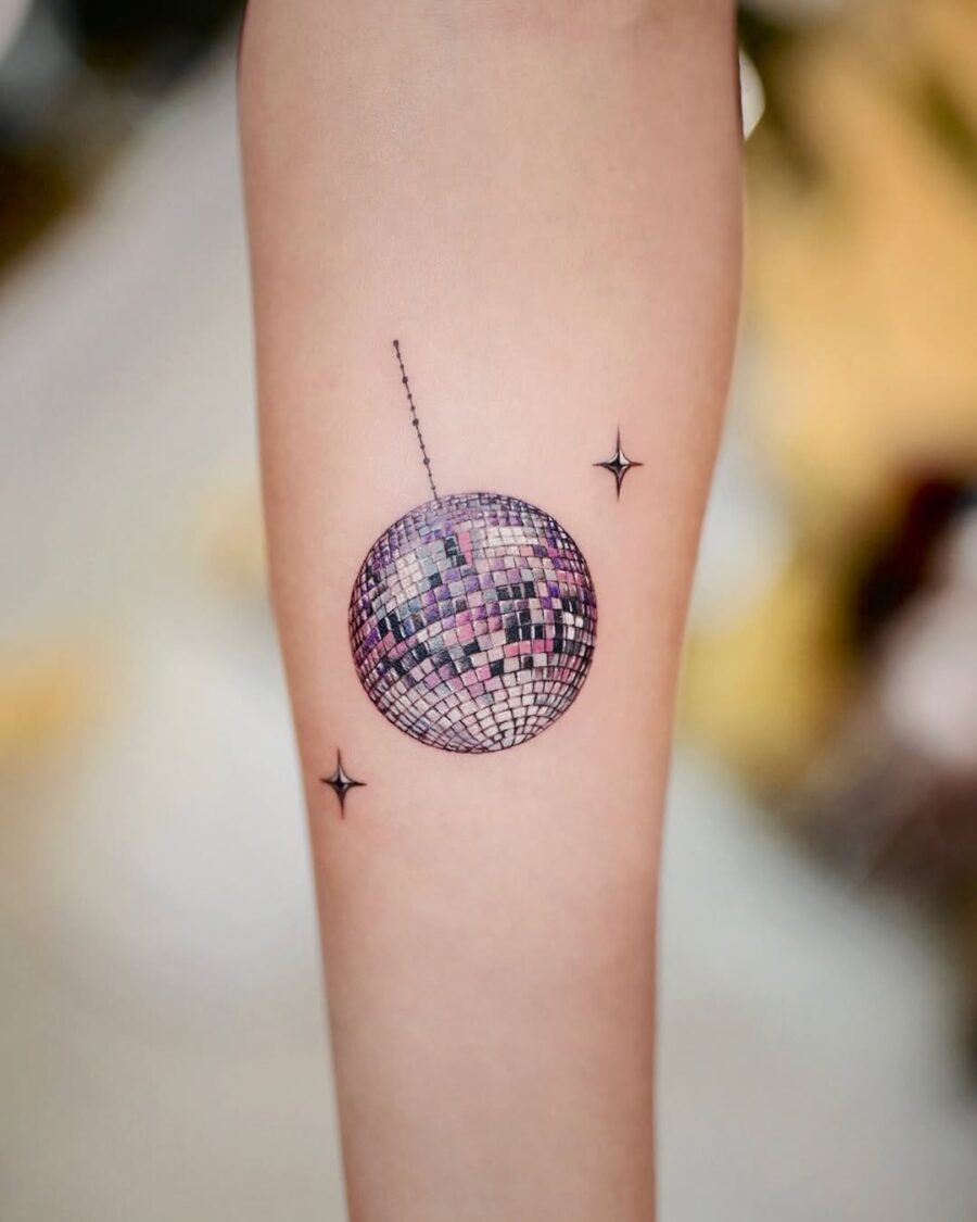Stylish disco ball tattoo with twinkling stars