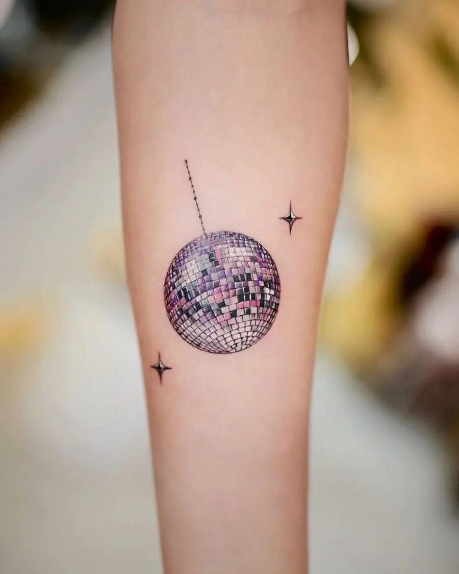 Stylish disco ball tattoo with twinkling stars