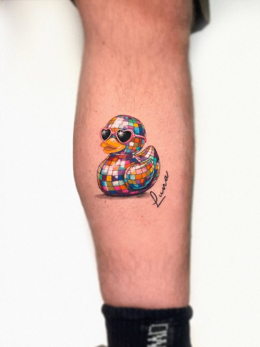 Vibrant disco duck tattoo on the leg
