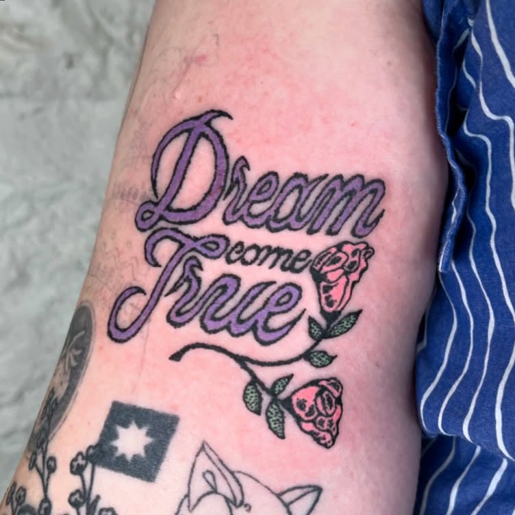 Elegant dream-themed tattoo with floral accents