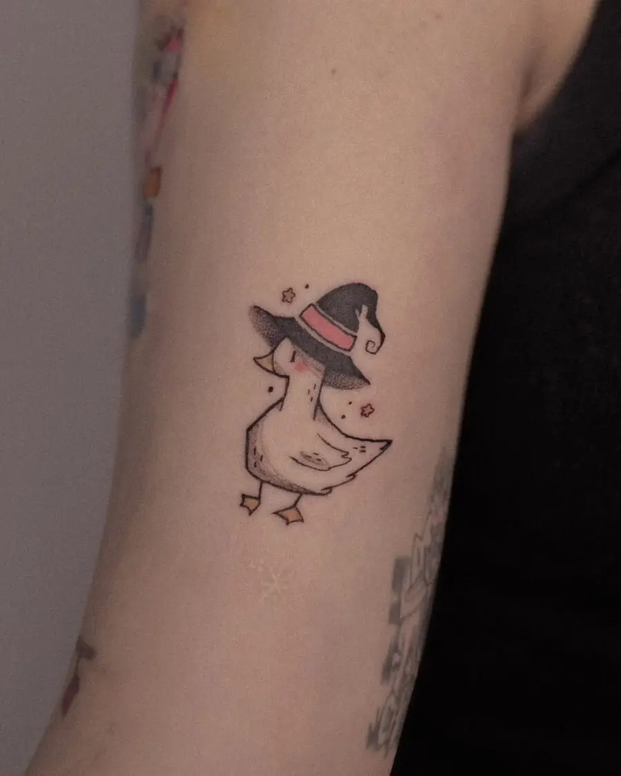 Adorable duck sporting a witch hat tattoo