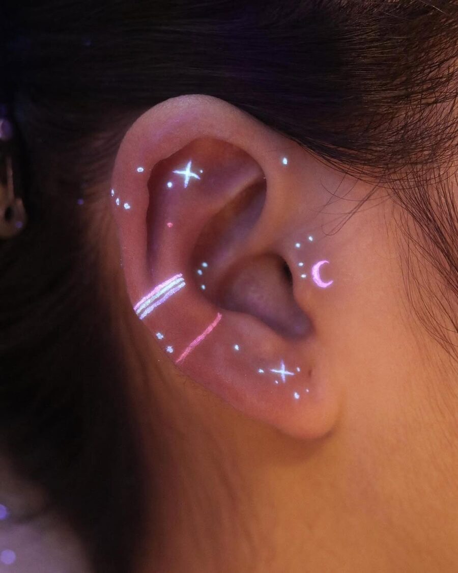 Glowing celestial design around the ear