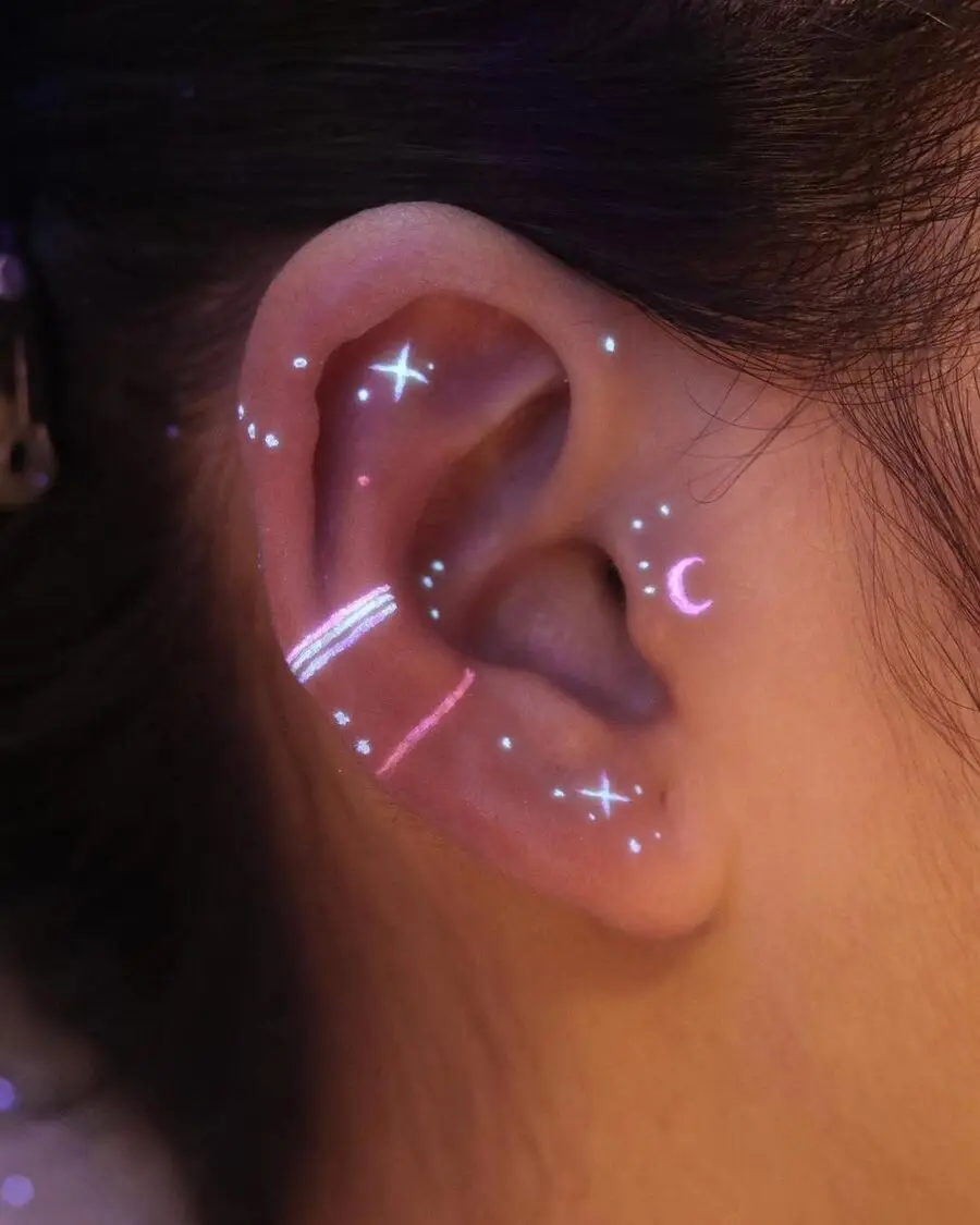 Glowing celestial design around the ear