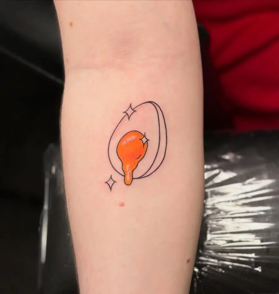 Vibrant Egg Tattoo Design with Sparkles