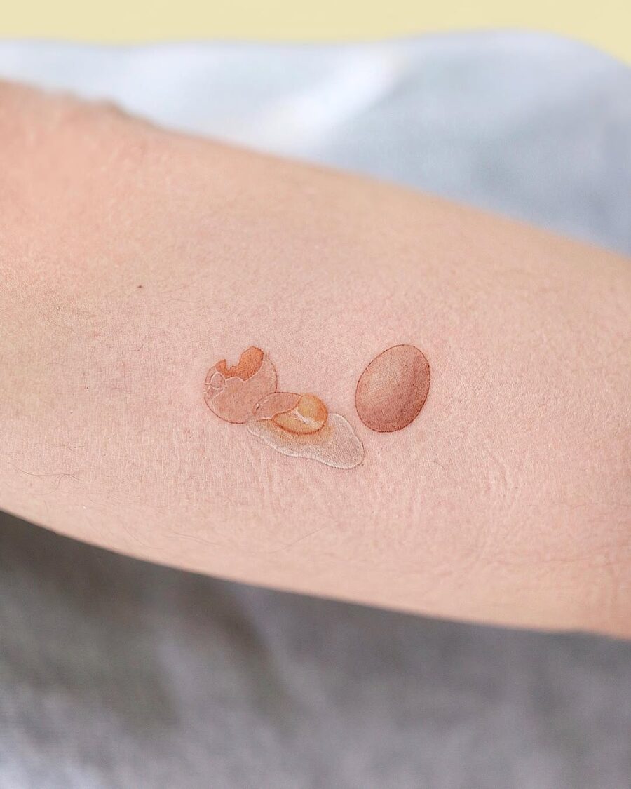 Realistic egg tattoo showcasing fresh elegance