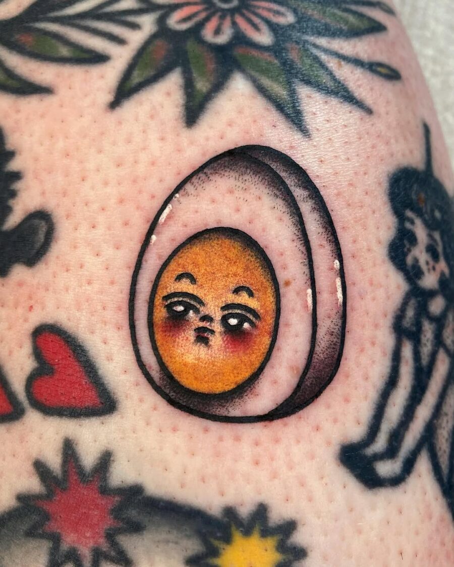 Quirky egg tattoo with expressive face