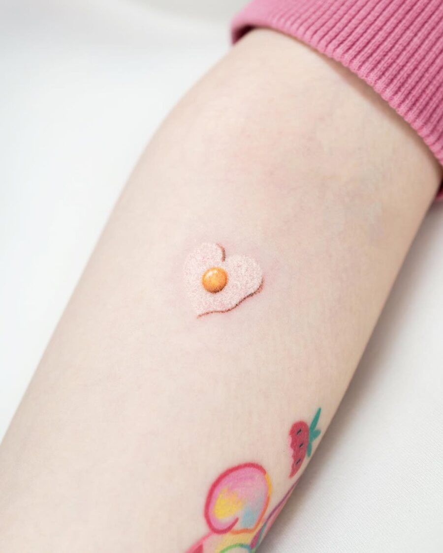 Sweet heart-shaped egg tattoo with a pearl.
