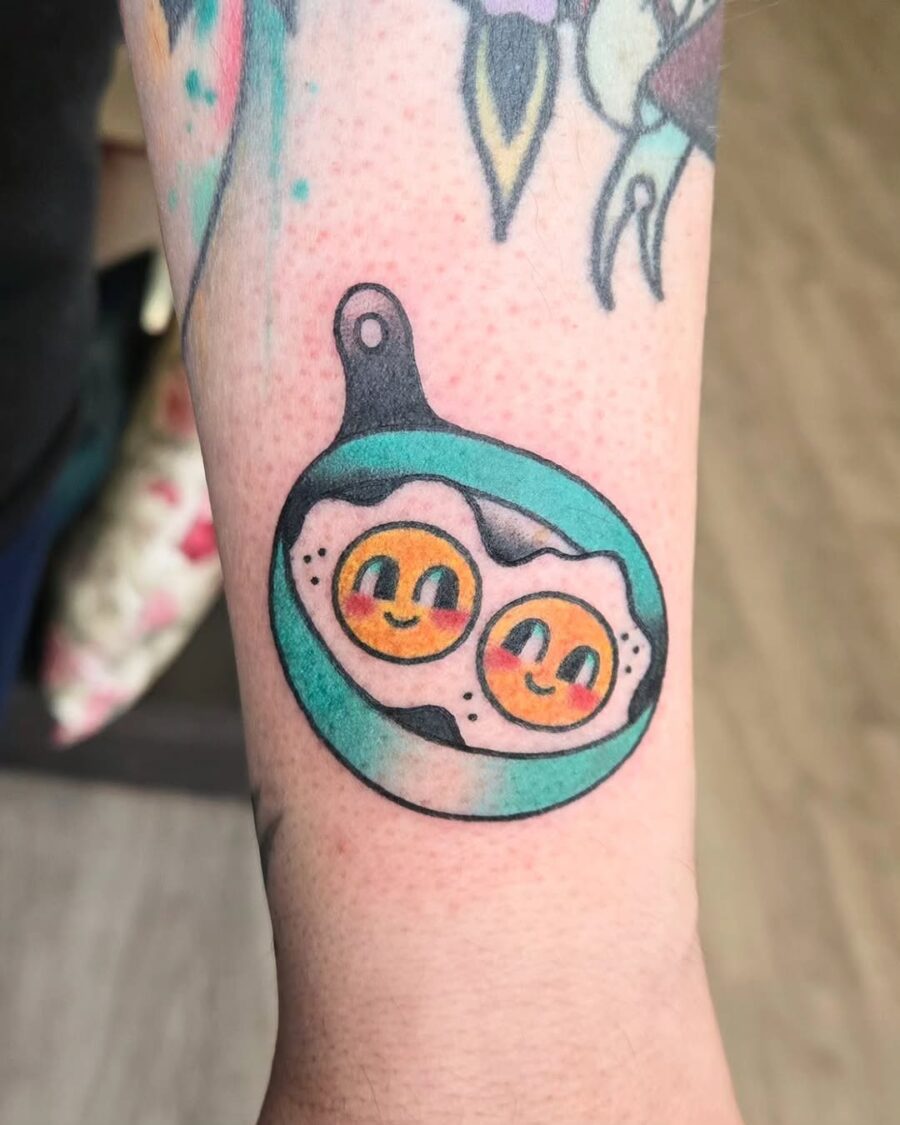 Playful Egg Tattoo in a Skillet Design