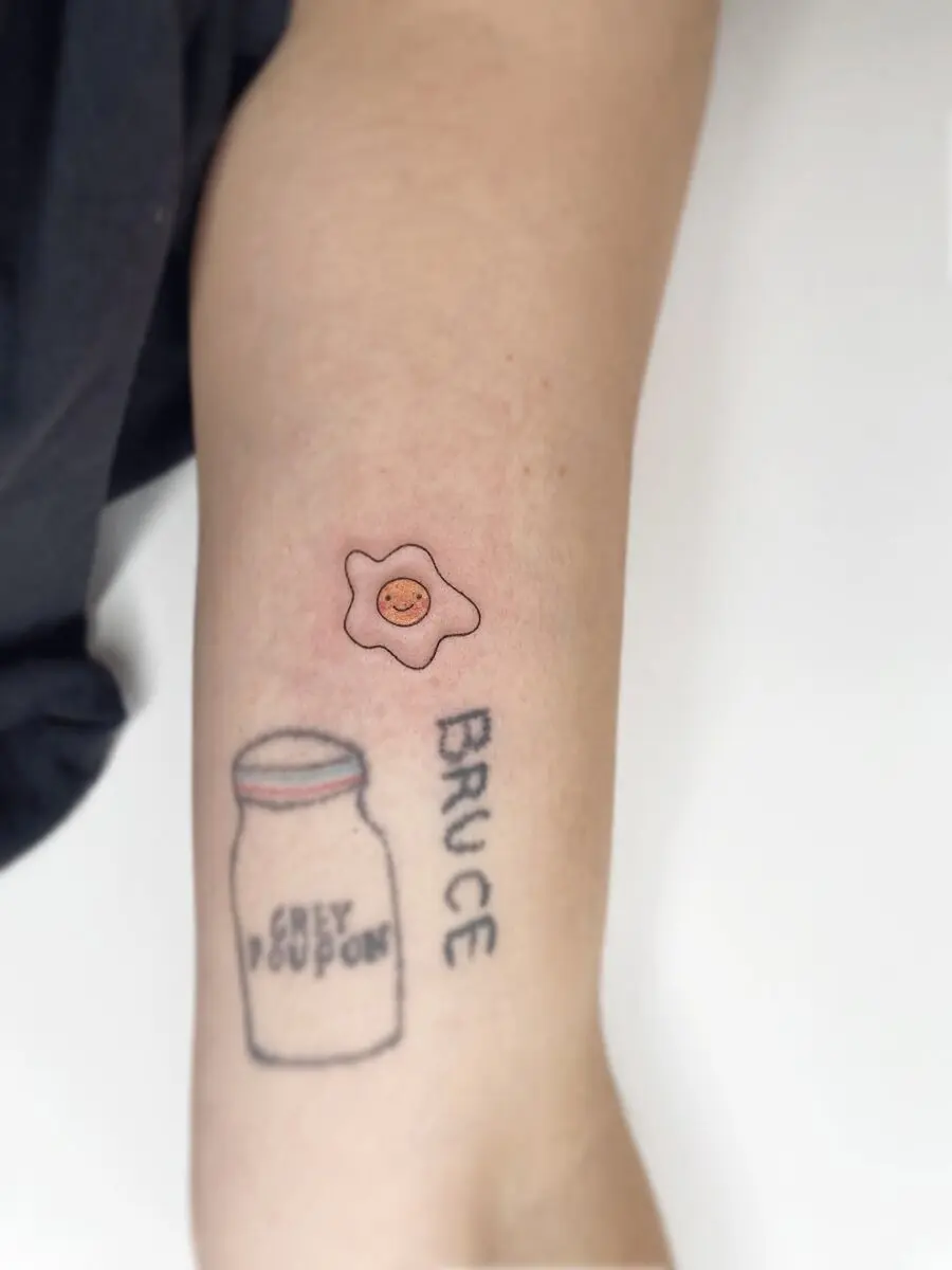 Charming Smiling Egg Tattoo on Arm