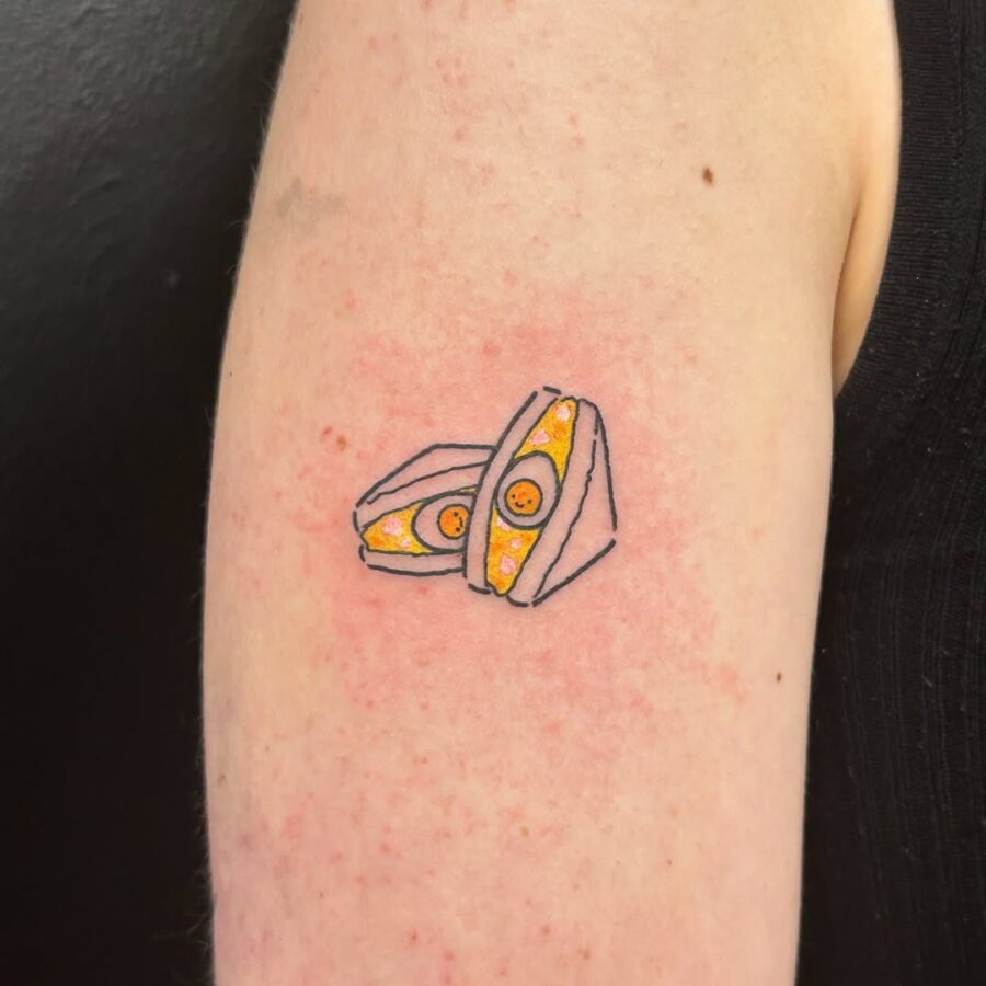 Creative egg tattoo with sunny-side up detail