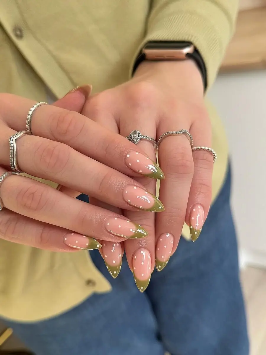 Chic green French tip nails with playful dots