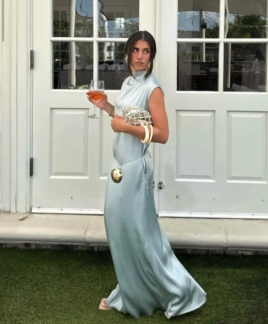 Elegant summer wedding outfit with a refreshing drink