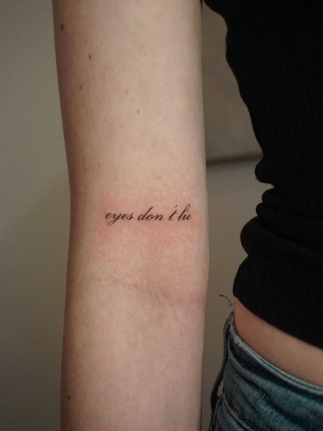 Elegant script tattoo with powerful wording