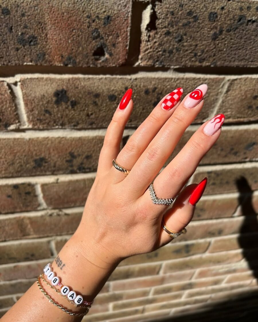 Vibrant red festival nails with unique patterns
