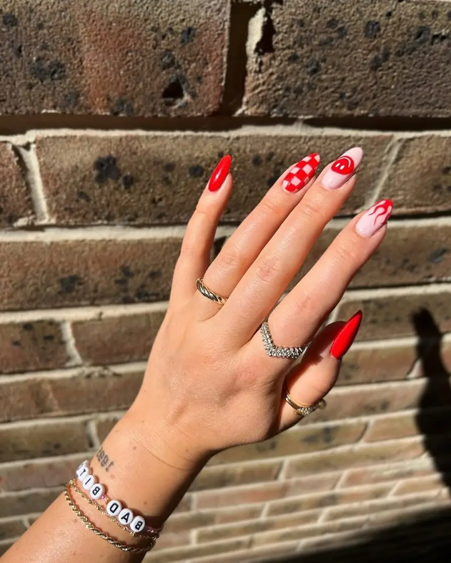 Vibrant red festival nails with unique patterns