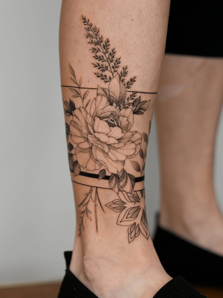 Elegant ankle tattoo with floral designs