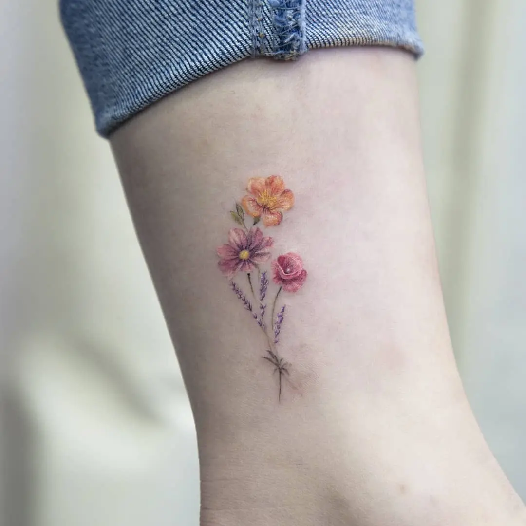 Delicate floral accents for ankle tattoos