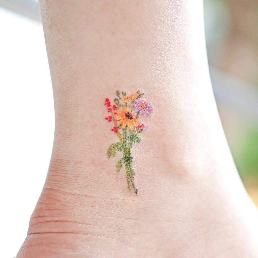Vibrant floral ankle tattoo for nature lovers
