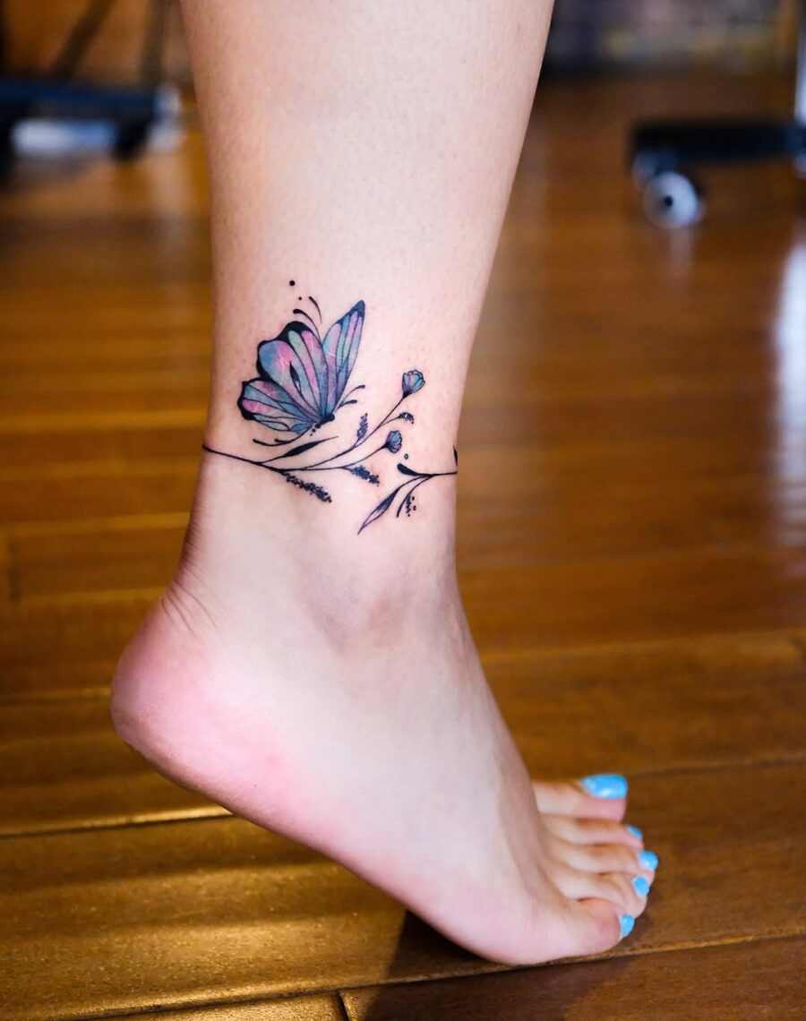 Delicate butterfly and floral ankle tattoo design