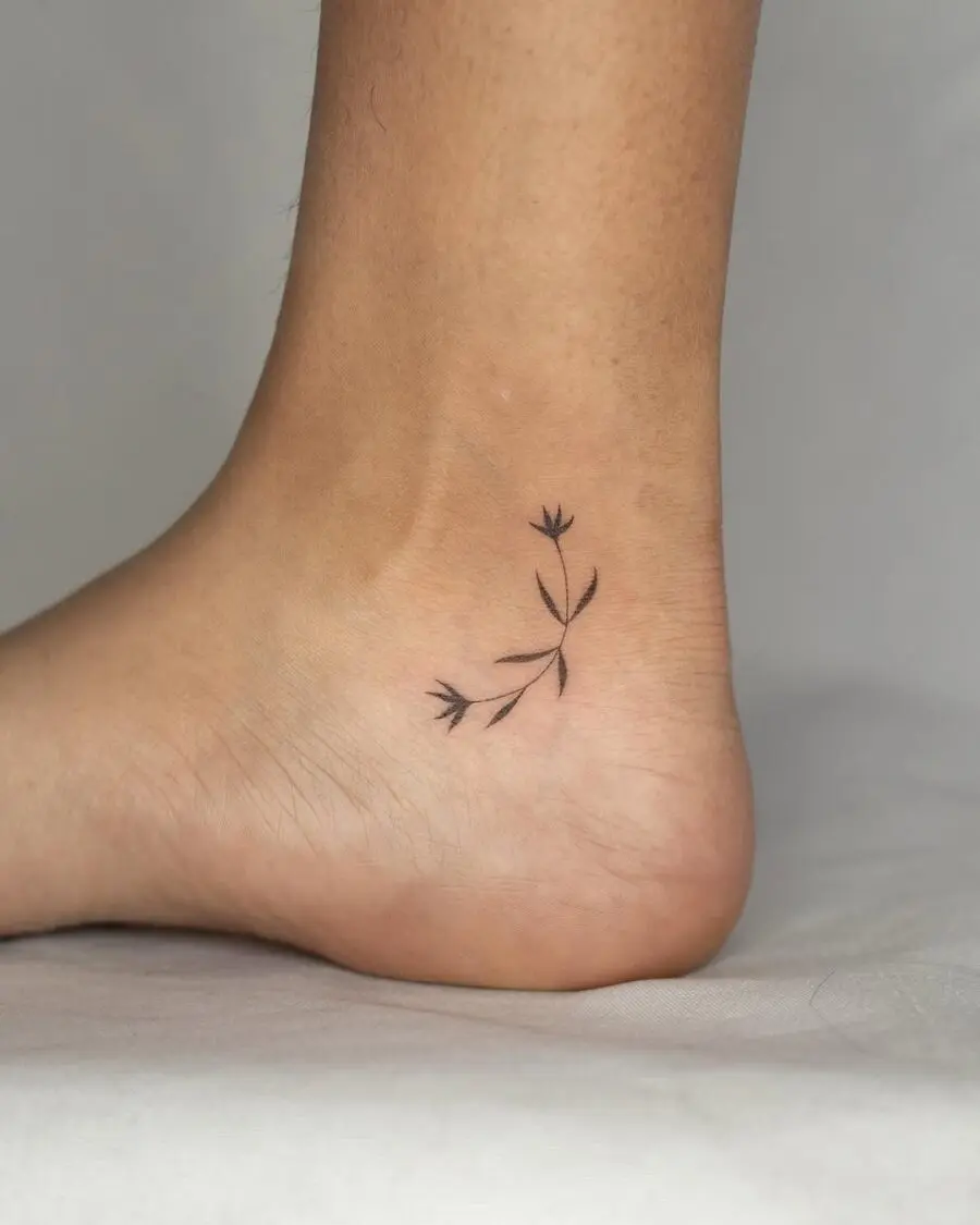 Minimalistic flower ankle tattoo with elegant curves